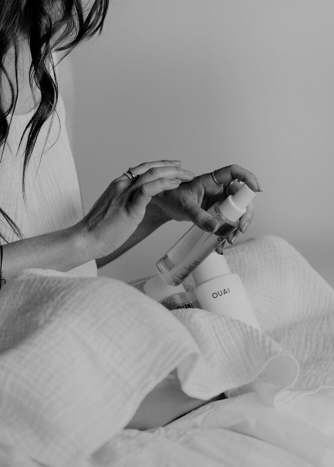Woman in White Tank Top Holding White Plastic Bottle